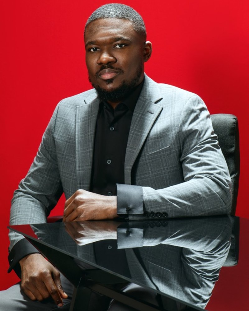 John Clerge, founder and CEO of Klikzo, in a grey suit